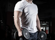 Male bodybuilder engaged with dumbbells in the gym