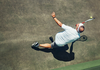 Sticker - That was close. High angle shot of a focused middle aged man playing tennis outside on a tennis court during the day.