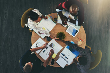 Poster - Their team just got one person bigger. High angle shot of businesspeople shaking hands during a meeting with colleagues.