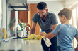 © Nikish Hiraman/peopleimages.com - The super disinfecting son and dad duo. Shot of a father and son cleaning the kitchen counter together at home.