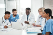 © Chanelle Malambo/peopleimages.com - Working together for their patients. Shot of a group of medical practitioners using a laptop during a meeting in a hospital boardroom.