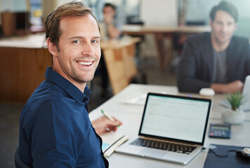 Poster - Focused on success and having fun doing it. Portrait of a designer working on a laptop in an office.