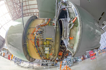 Wall Mural - Repairs the maintenance of a large engine- the bonnet flap is open, passenger aircraft in a hangar.