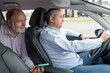 © Renata Hamuda - elderly passenger in back seat showing smartphone to car driver-concept of transportation, cab, taxi and technology