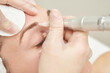 © elenavolf - Permanent makeup. Beauty spa procedure. young woman. Face tattoo. Eye micropigmentation. Professional face microblading. Female cosmetology device. Copyspace. Mouth treatment. Dermatology