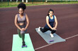 © etonastenka - Active lifestyle in the city. Image of young women doing stretching after running workout