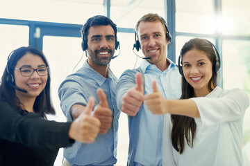 Poster - Keep on giving your best effort. Portrait of a team of call centre agents showing thumbs up together in an office.