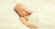 Close up portrait of infant sweet sleeping on white bed at home