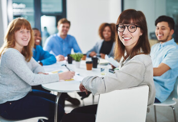 Poster - Young movers and shakers. Cropped portrait of a group of young businesspeople sitting in a boardroom during a meeting.