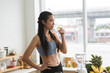 © chokniti - young Asian woman cooking vegetable healthy food and eating or drinking in home kitchen