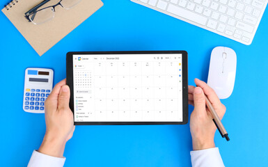 Poster - Person using a tablet computer, On the workstation, a tablet with Calendar app on tablet 
