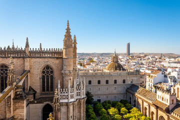 View from the Giralda Tower out over the courtyard of the Seville Cathedral with the city and Sevilla Tower Skyscraper in view.