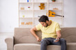 © Elnur - Young man sitting at home during pandemic