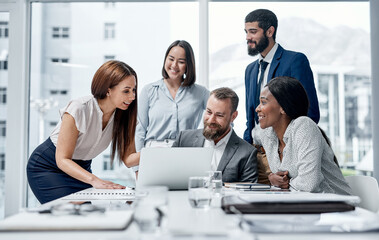 Aufkleber - Working through different problem-solving approaches. Shot of a group of businesspeople working together on a laptop in an office.