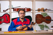 © Elnur - Young man repairing musical instruments at workshop