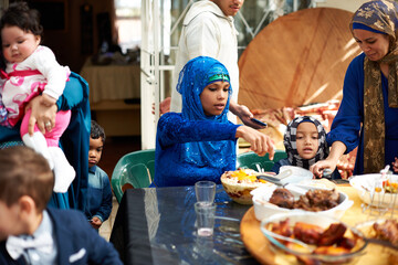 Sticker - Food brings everyone together. Shot of a muslim family eating together.