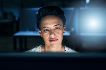 Poster - Being tired is part of the job. Shot of a tired young female programmer working on a computer in the office at work during the night.