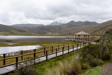 Wall Mural - Cotopaxi National Park. Observation deck and wooden walkway at lake Limpiopungo on an overcast rainy day. Cotopaxi province, Ecuador