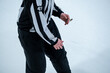 © Marko Hannula - Ice hockey linesman holding a whistle and watching the game
