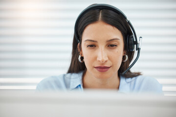 Poster - Challenges are always welcome. Shot of an attractive young saleswoman sitting alone in her office and wearing a headset.