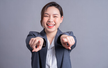 Wall Mural - Portrait of a beautiful Asian businesswoman on a gray background