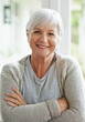 © Anne/peopleimages.com - Happy in the knowledge that Ive planned for my retirement. A happy senior woman smiling at the camera as she sits in her home.