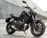 Custom black motorcycle parked outdoors in city in daytime