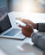 © Nikish Hiraman/peopleimages.com - Banking couldnt be more efficient. Cropped shot of an unrecognizable businessman holding his credit card while using a laptop at his desk.