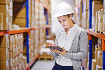 Poster - Digital tracking for shipping ease. Shot of a woman at work in a storage warehouse.