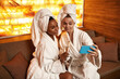 © Svitlana - Girlfriends take selfie on smartphone in spa salon