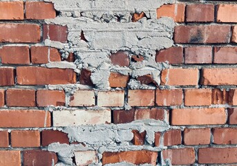 Wall Mural - a wall of red old bricks smeared with mortar