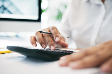 Aufkleber - What does that equal to. Shot of an unrecognizable businessperson using a calculator in an office.