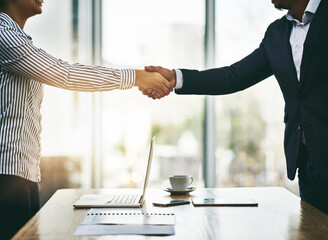 Poster - Doing business together works to both of our favors. Closeup shot of two businesspeople shaking hands in an office.