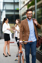 Portrait Of Happy Fit Business Man With Bicycle In Modern City Outdoors.