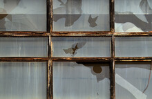 Broken Window Panes In A Metal Frame.Rusty Metal Frames On The Window.Dirty, Broken Windows.