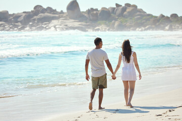 Poster - Hold my hand and never let go. Shot of a young couple enjoying a day at the beach.