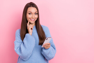 Poster - Photo of cute young brown hairdo lady hold telephone wear blue sweater isolated on pink color background