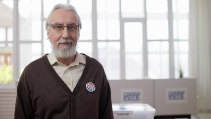 Wall Mural - Portrait of responsible senior voter at polling station, fulfilling civic duty