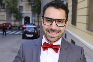 Charming man wearing tuxedo and elegant eyeglasses