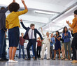 © Alexandra/peopleimages.com - Office entertainment. Shot of a businessmen dancing in the centre of a circle of coworkers.