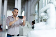 © JackF - Adult man is visiting museum and taking photo of exposition by phone indoor.