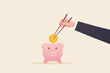 © yellow_man - Asian people's savings concept. A businessman's hands hold gold coin chopsticks and drop coins into the piggy bank.