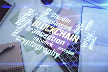 Poster - Blockchain theme hologram drawings over computer on the desktop background. Top view. Multi exposure. Concept of cryptoeconomy.