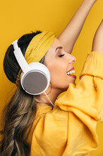 Delighted Woman Listening To Music In Headphones