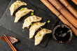 Jiaozi Chinese gyoza dumplings on a dark table top view. Chinese cuisine.
