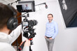© W PRODUCTION - young man video camera operator making interview in professionnal broadcast tv movie studio film production