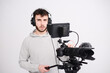 © W PRODUCTION - portrait of a young man video camera operator making interview in professionnal broadcast tv movie studio film production with a dslr camera