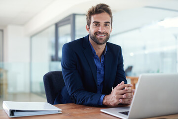 Aufkleber - Confident about business. Shot of a young businessman sitting at a desk in front of a laptop.