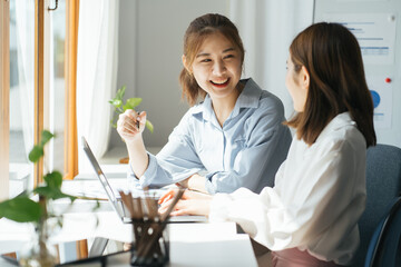 Two diverse serious businesswomen discussing business project working together in office, serious female advisor and client talking at meeting, focused executive colleagues brainstorm sharing ideas