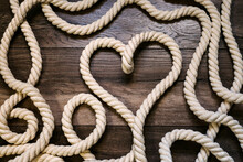Symbol Heart Made Of Rope On A Wooden Background